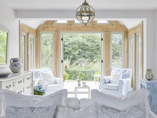 large white sunroom in oak frame home