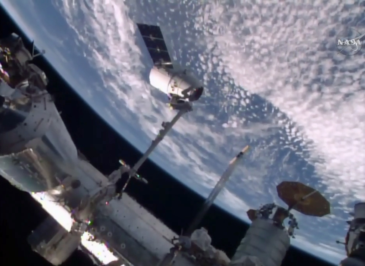 SpaceX&#039;s Dragon cargo ship is captured by the International Space Station&#039;s robotic arm in this view from an exterior camera on April 10, 2016. The unmanned Dragon delivered 7,000 lbs. of supplies to the space station for NASA.