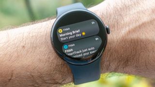 The Pixel Watch 3 on a user's wrist showing the Morning Brief