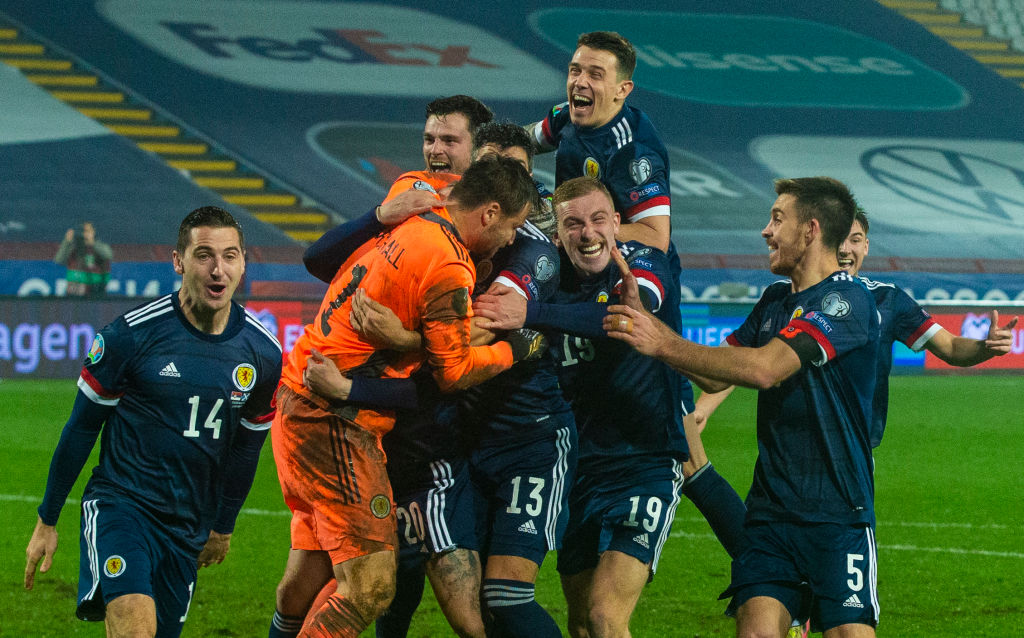 Scotland players celebrate after David Marshall saves Aleksandar Mitrovic's penalty to seal qualification for Euro 2020