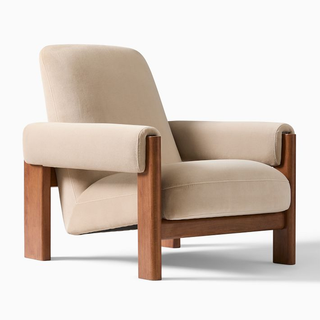 modern low-profile chair with velvet cushion, armests and wooden frame