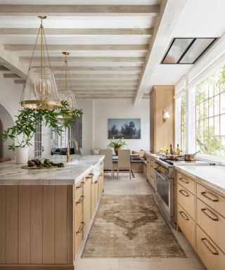 Modern farmhouse kitchen with wood lower cabinetry and stone countertop