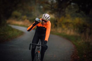 Male cyclist drinking an energy drink during a bike ride