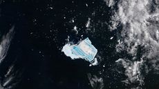 Satellite photo of an iceberg covered with vibrant blue stripes in the middle of the ocean
