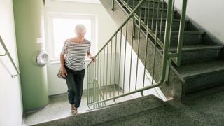 A woman walks up a flight of stairs