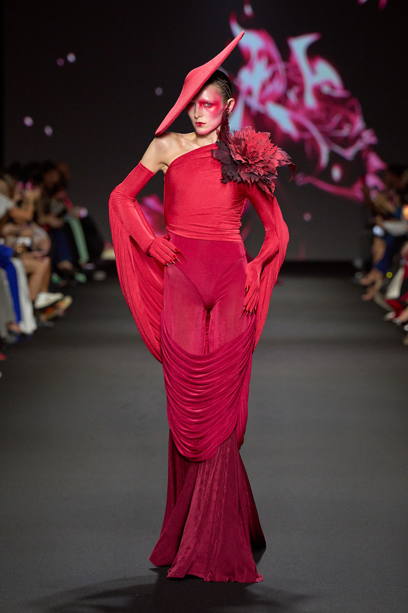 A model wore Olandria Carthen's red look on the Robert Wun Fall 2024 Couture runway