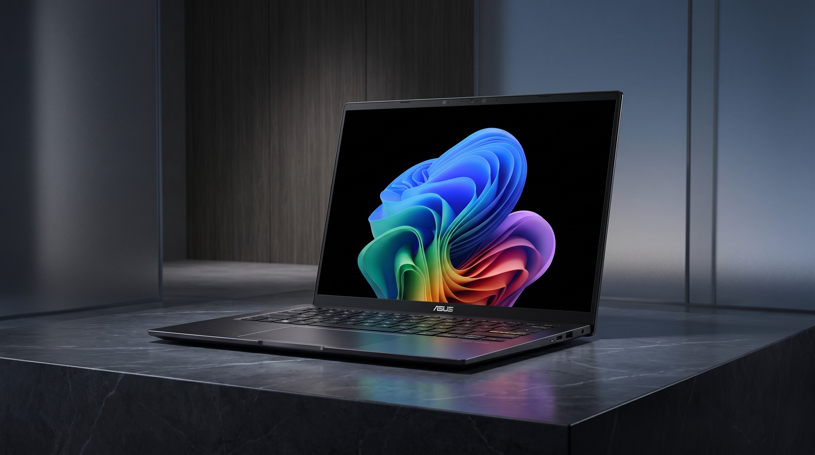 An Asus Vivobook 16 on a black marble table