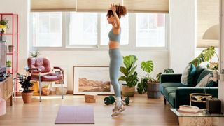 Woman performing burpees at home