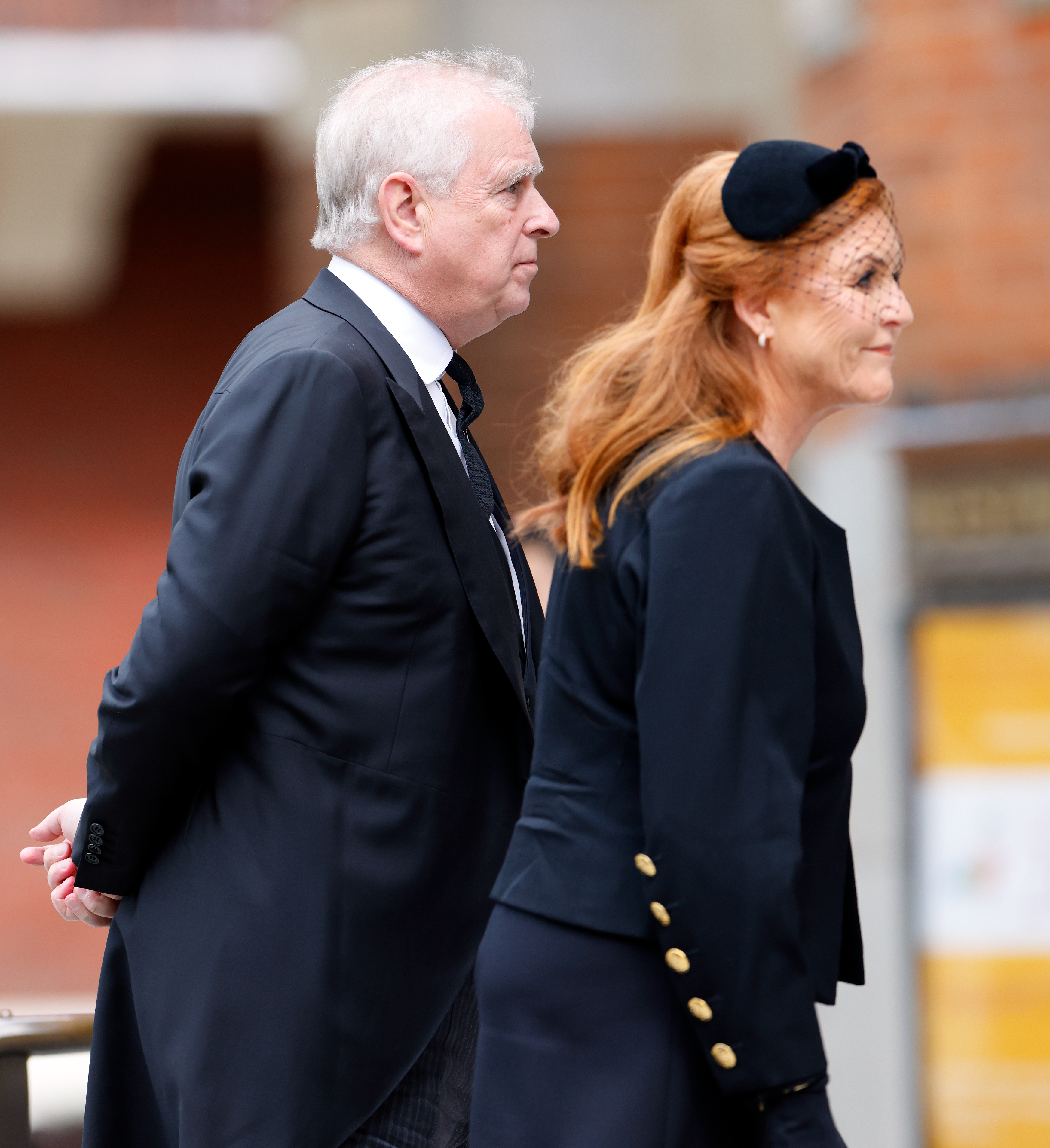 Sarah Ferguson and Prince Andrew walking into church in black outfits