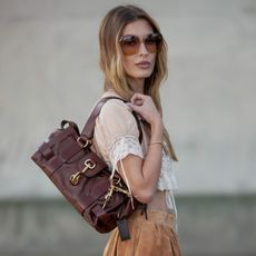 woman wearing a burgundy leather bag