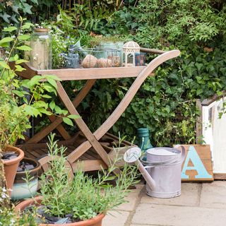 garden area with wooden trolley and potted plants