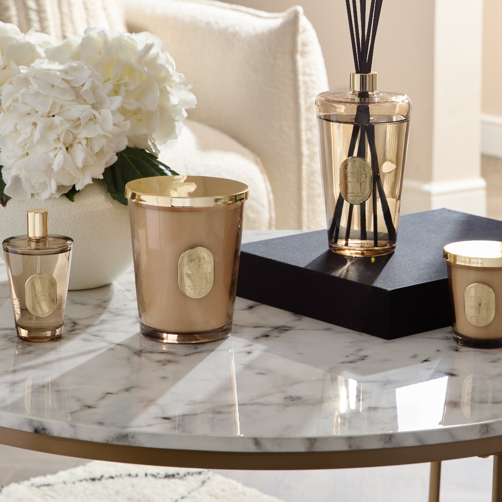 A marble coffee table displaying home fragrance from Primark's The Edit homeware collection