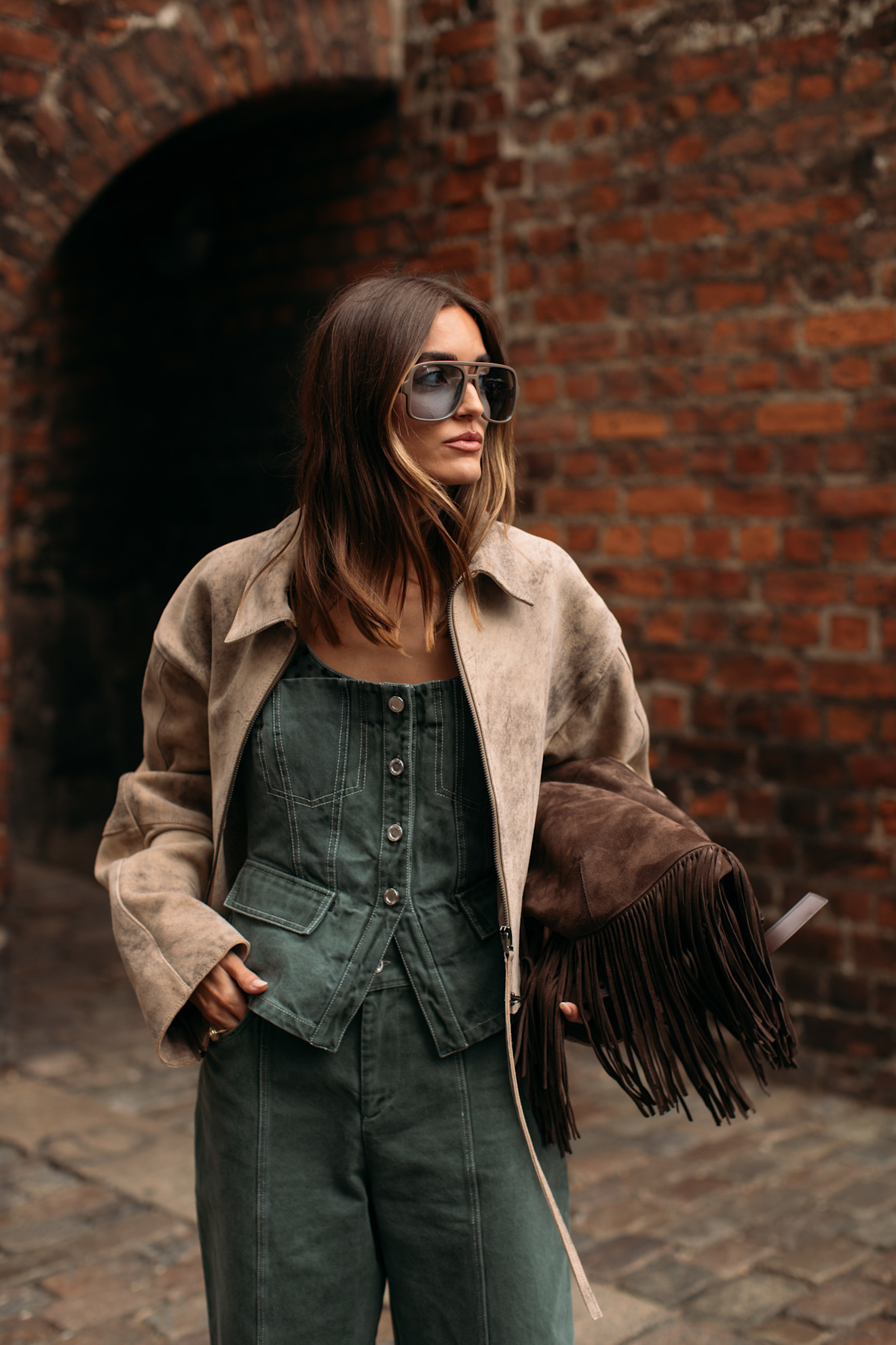 woman wearing a suede jacket over double-denim