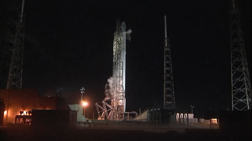 A SpaceX Falcon 9 rocket and Dragon spacecraft stand atop a pad at Cape Canaveral Air Force Station in Florida after an aborted launch attempt on Jan. 6, 2015 due to a technical issue on the rocket&#039;s second stage.