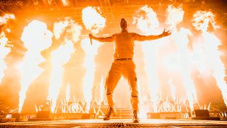 Winston McCall on stage in 2022 surrounded by fire