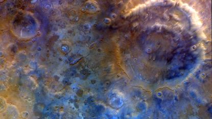 A close up of the surface of Mars, with blue and red colors.