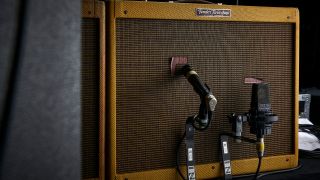 Two microphones in front of a Fender guitar amp