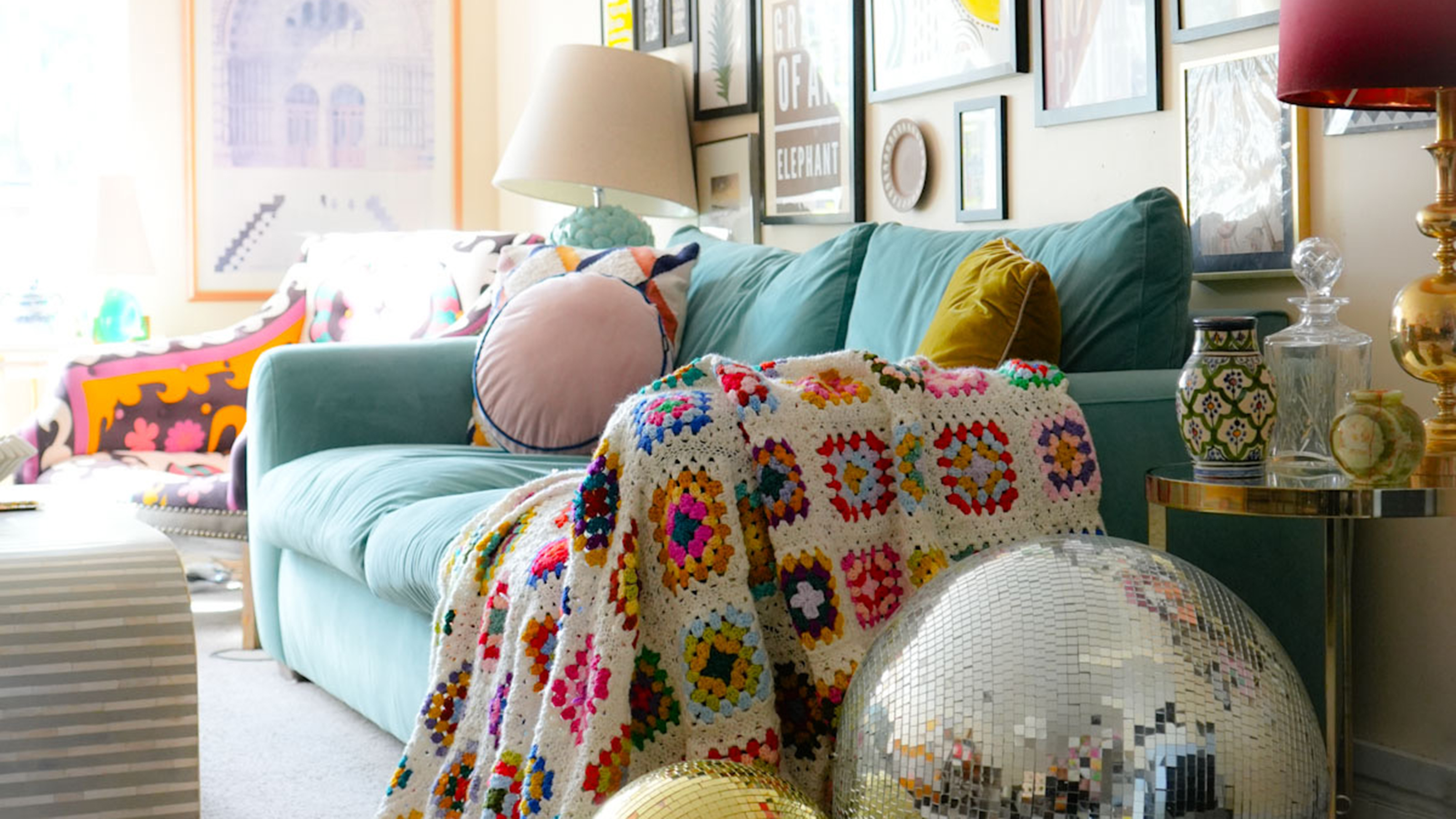 pale blue sofa in a living room with glitter balls by the side of it