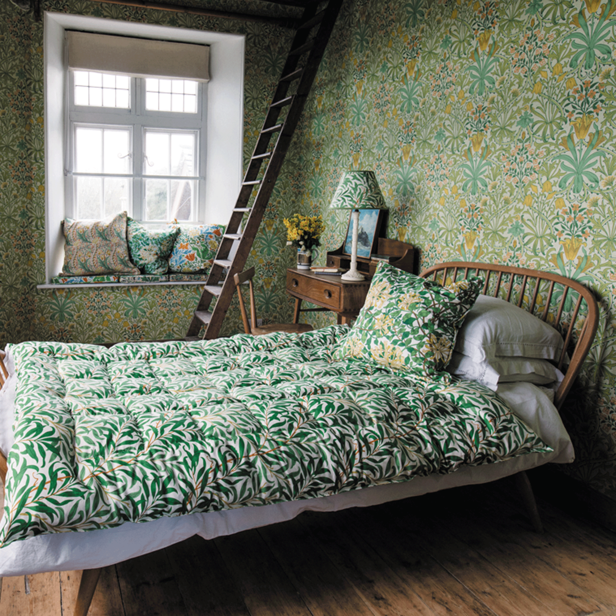 Bedroom with patterned wallpaper, bedding and. lampshade