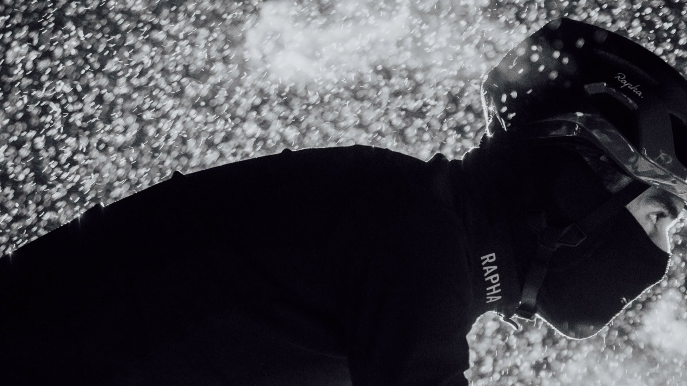 Male rider in Rapha kit cycling in snow