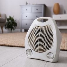 Electric fan heater standing up in room