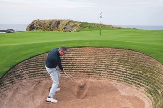 Steve North playing a greenside bunker shot on the 10th hole at Trump Turnberry