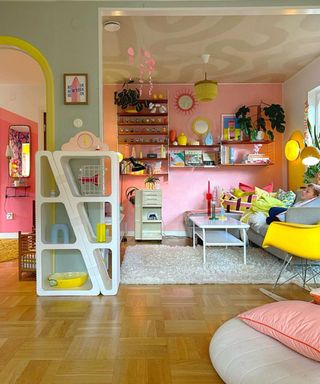 A colorful living room with vertical storage shelves, a couch, and coffee table