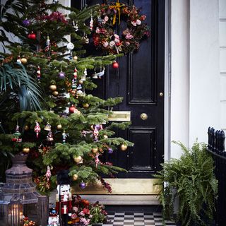 christmas tree with decoration and black door