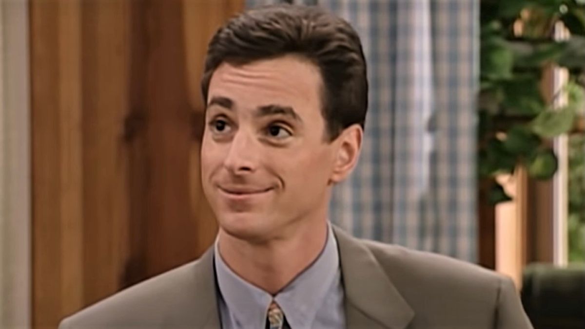 Bob Saget as Danny Tanner, smiling on Full House.