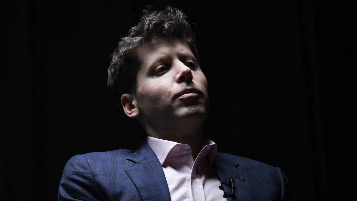 The OpenAI CEO Sam Altman in a darkly lit room