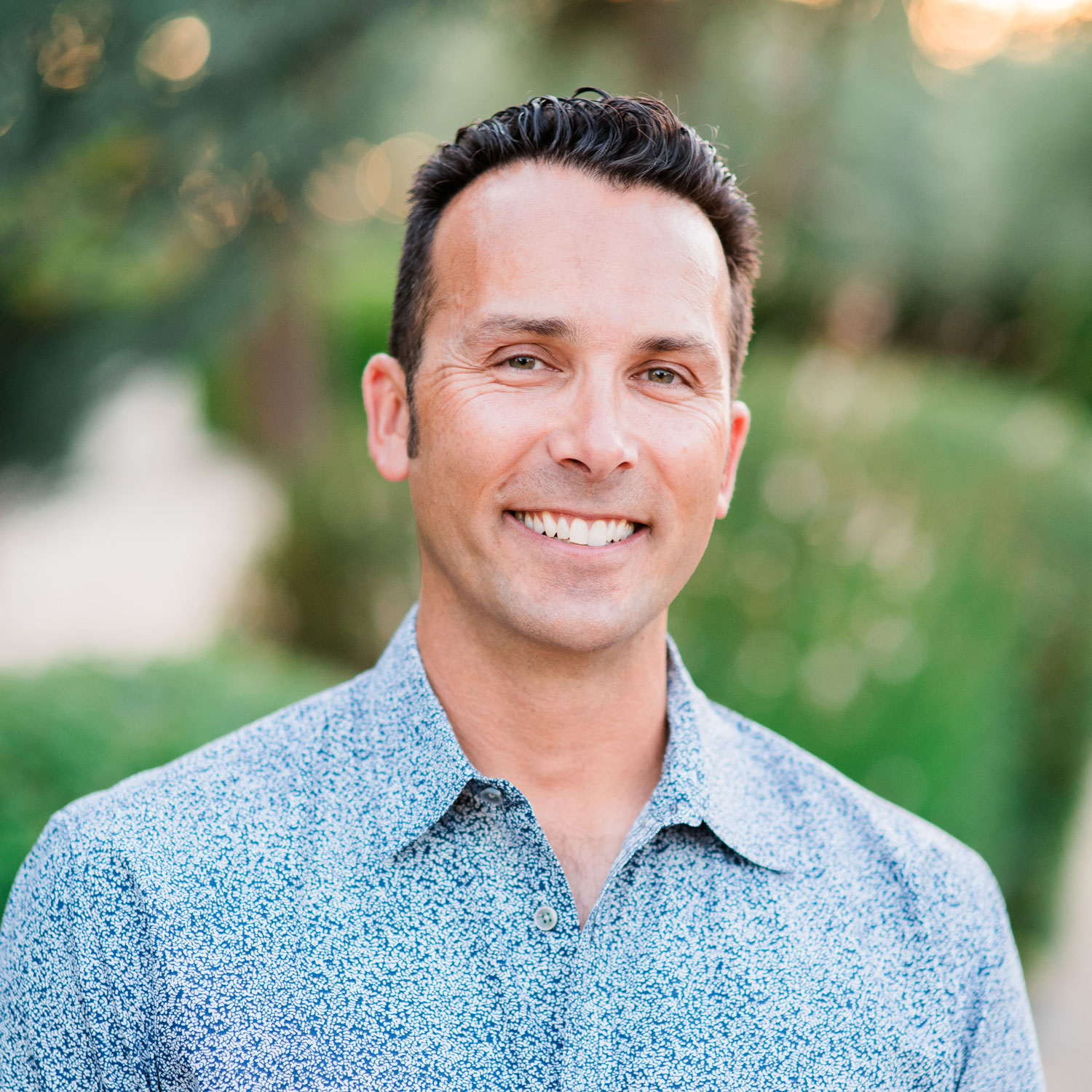 Drew Montell, Director of Engineering and Product Development at Ernie Ball Music Man, pictured in a light blue patterned shirt