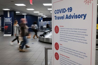 Signs warn travelers of Covid-19 in New York’s LaGuardia Airport