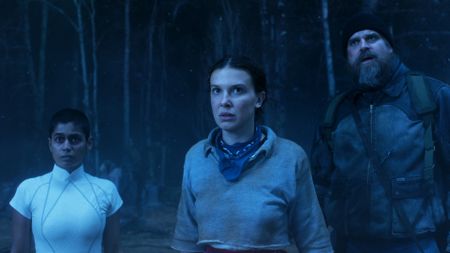 Kali, Eleven, and Hopper looking at something off-camera in the Upside Down in Stranger Things season 5