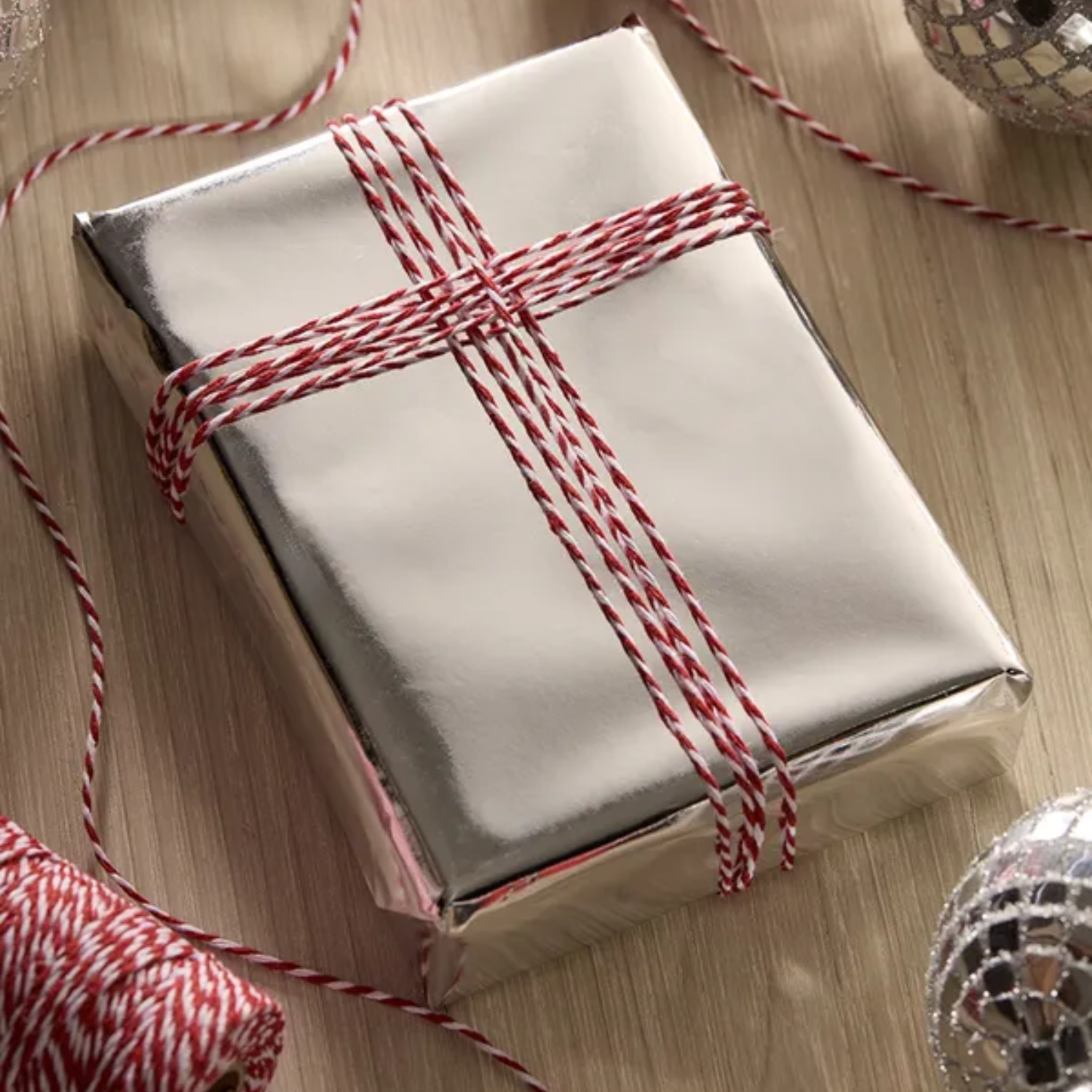A gift in chrome paper with red and white thread