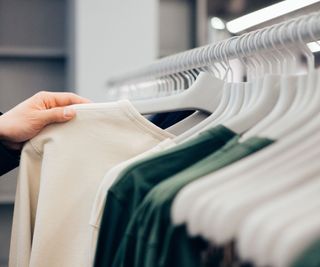 Clothes hang neatly on a clothes rail