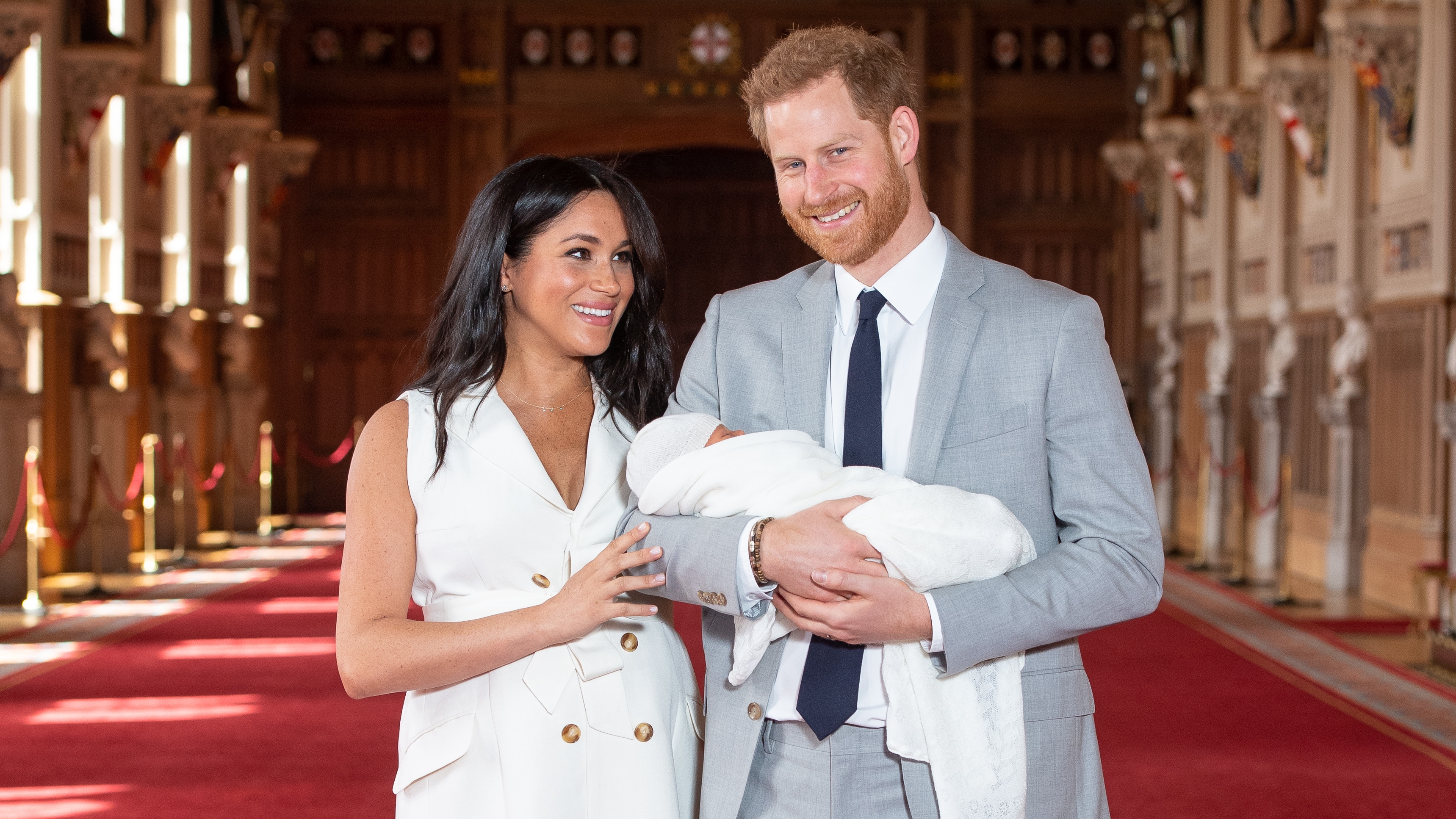 Prince Harry, and Meghan, Duchess of Sussex, pose with their newborn son Archie during a photocall in St George&#039;s Hall at Windsor Castle on May 8, 2019