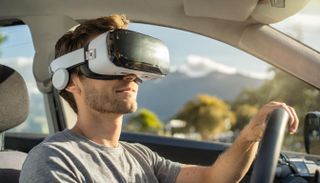 A man wearing a mixed-reality headset while driving