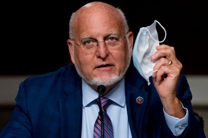Centers for Disease Control and Prevention Director Dr. Robert Redfield holds up his mask during a Senate Appropriations subcommittee hearing on a review of Coronavirus Response Efforts on Ca
