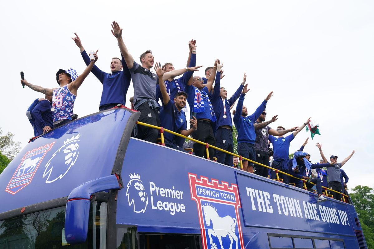 Ipswich Town players during an open-top bus parade in Ipswich to celebrate promotion to the Premier League