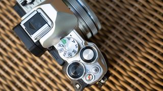 Olympus OM-D E-M10 Mark IV top view with mode dials and shutter release button