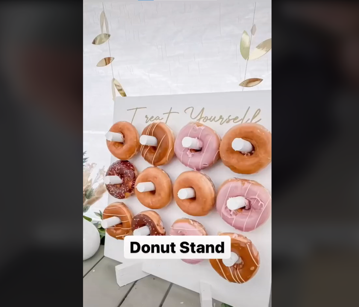 DIY donut stand with range of donuts on the hooks
