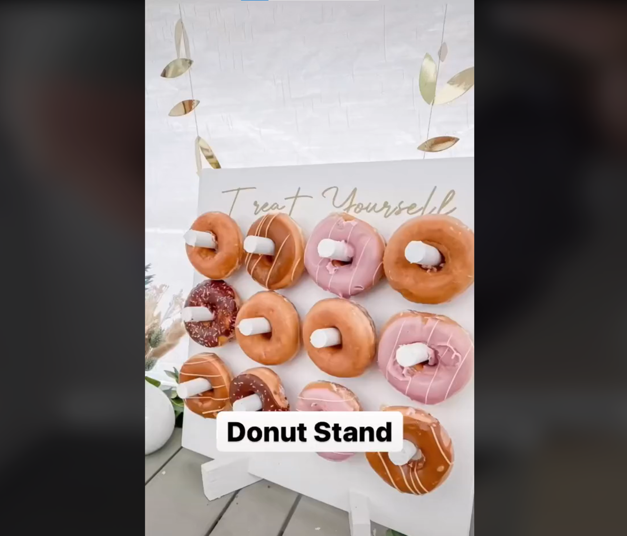 DIY donut stand with range of donuts on the hooks
