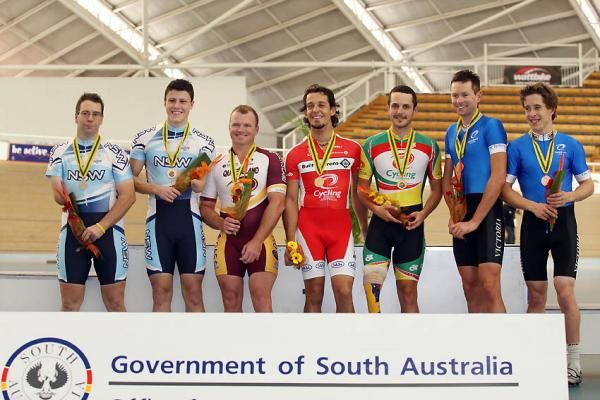 The medal winning para-cyclists are presented with their medals.
