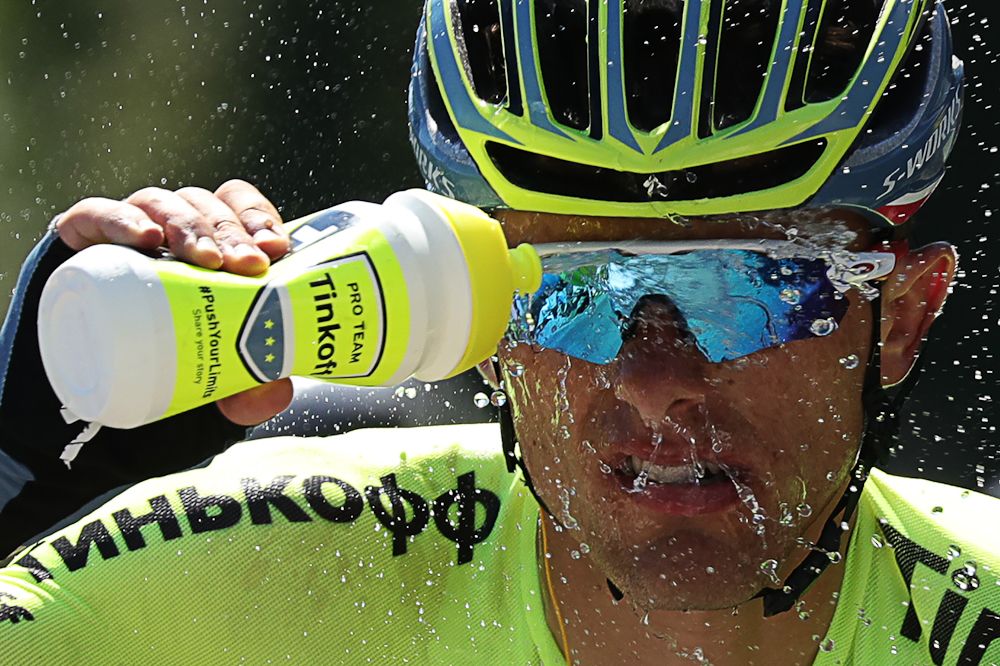 Rafal Majka soaks himself with water while he rides in the breakaway during stage 15.