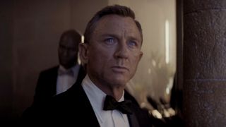 Daniel Craig as James bond in a black tux and bow tie in No Time to Die (2021).