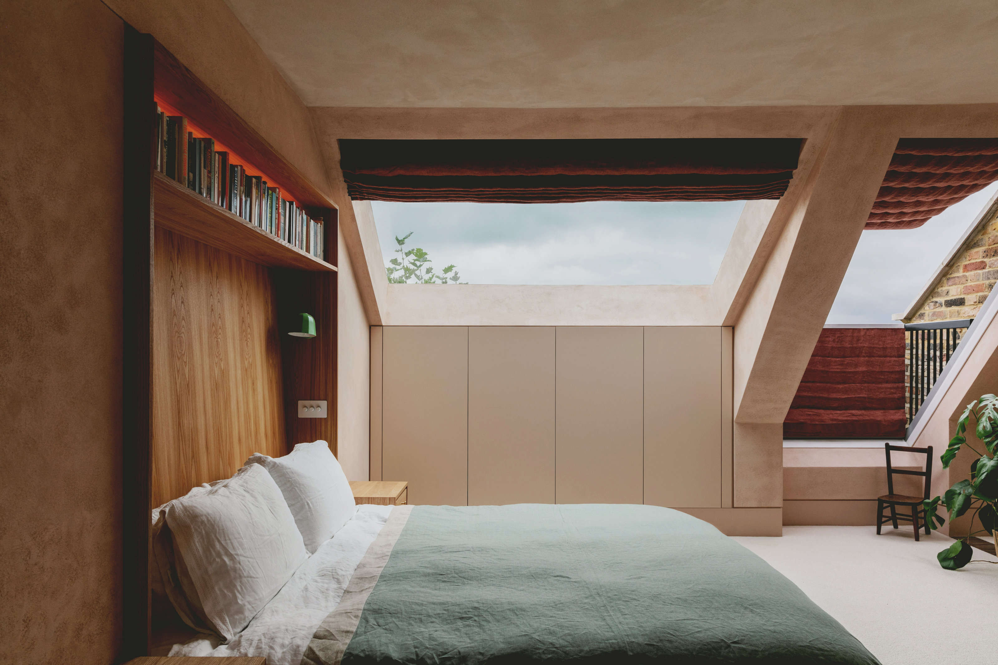 Loft bedroom with huge skylight, built-in headboard with shelving