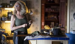 Halloween (2018) Jamie Lee Curtis Laurie prepares her weapons in the kitchen