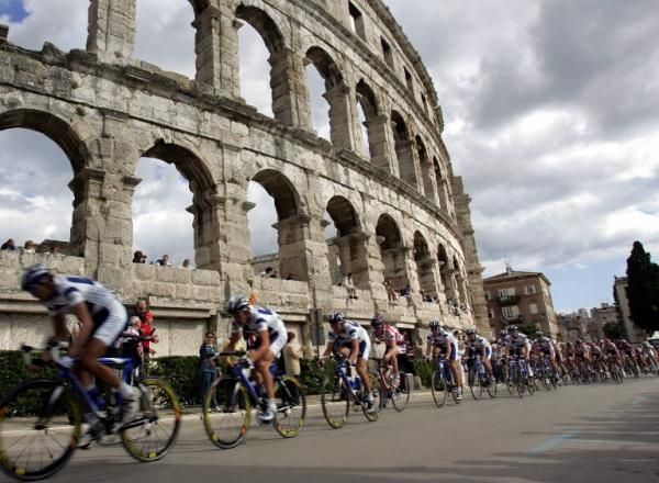 The Giro peloton races past an old Roman amphitheater in the northern Croatian Adriatic town of Pula.