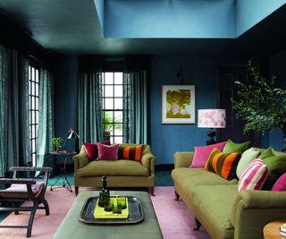 Lighting in a dark green-blue living room with green sofas