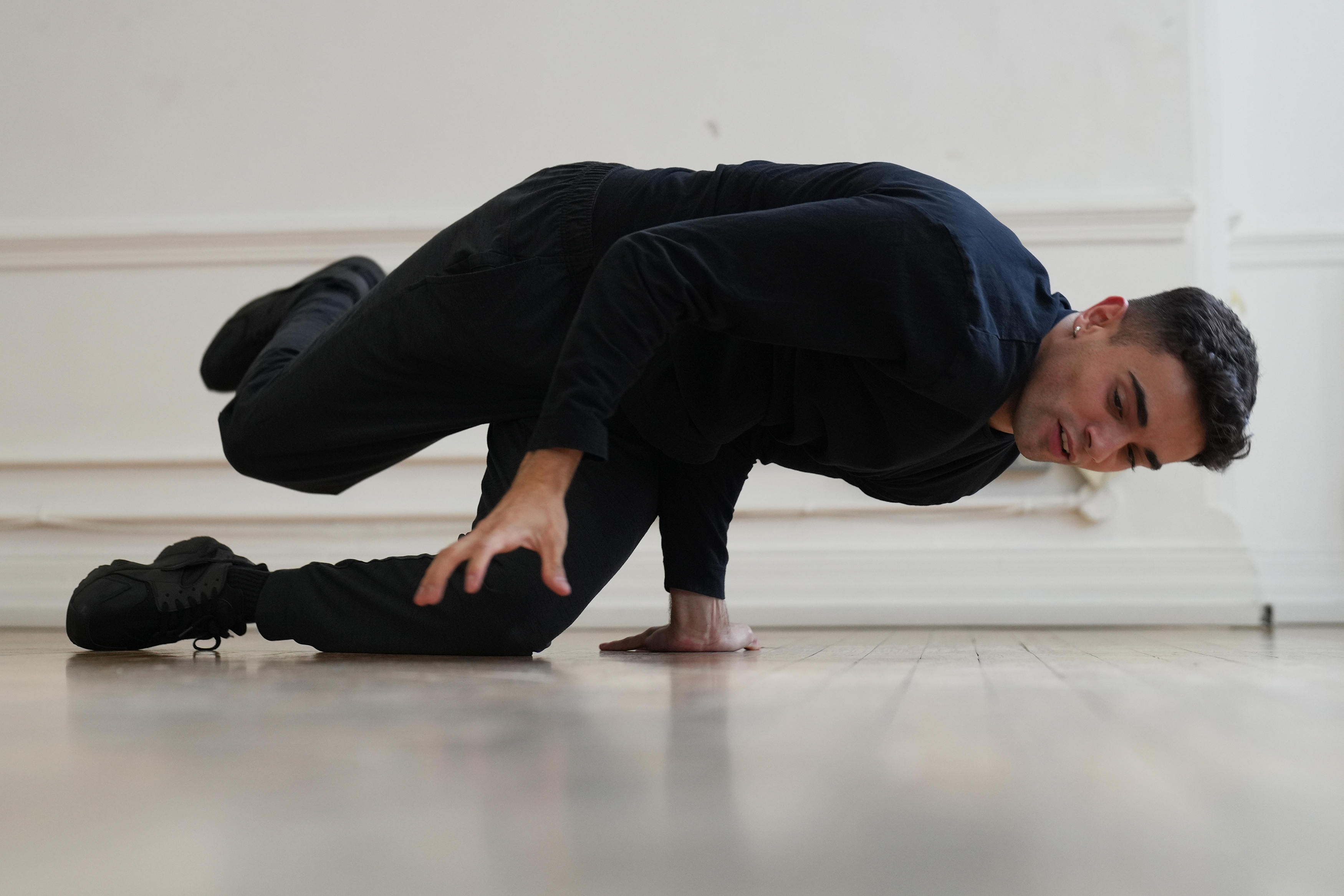 A man break dancing in a studio
